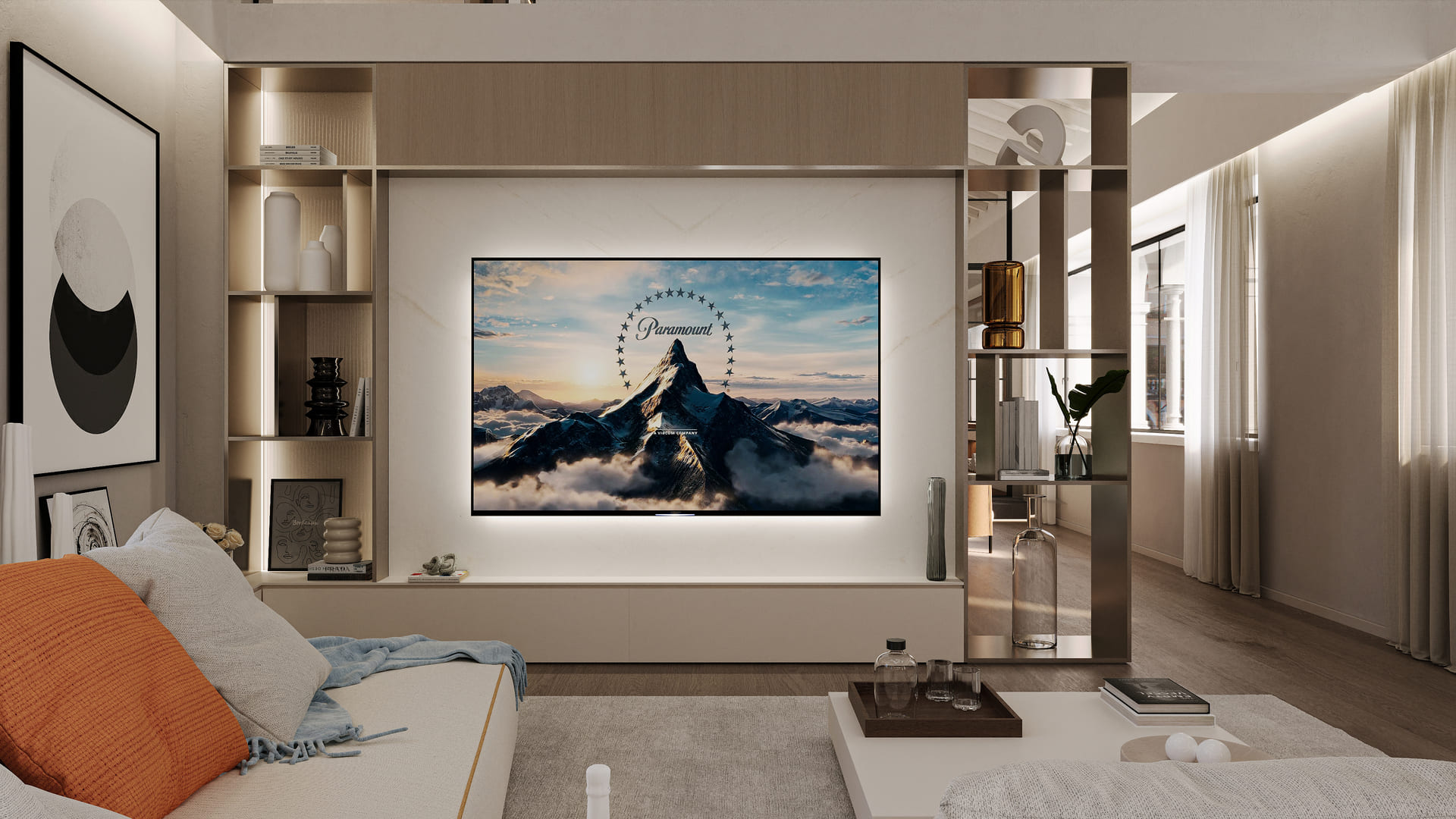 A modern living room with built-in shelving, a large TV displaying the Paramount logo, and a cozy seating area with neutral tones and decorative accents.