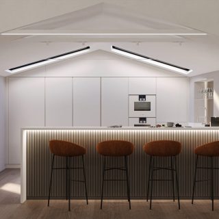 Minimalistic kitchen interior with white cabinetry, skylights, and a ribbed island bar with three brown stools.