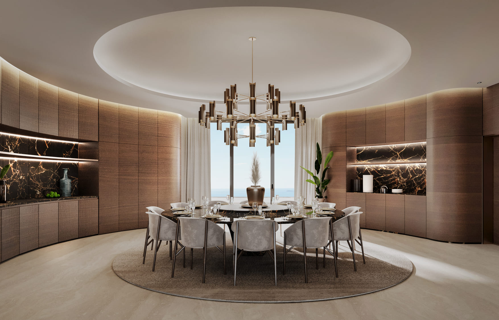 This image shows a modern dining room with a large, circular dining table set for eight. The chairs are upholstered in a plush material, and the table is set with plates, glasses, and cutlery. A striking chandelier hangs above, and the room features a contemporary design with a neutral color palette. The back wall is adorned with marble accents and backlit panels, creating a luxurious ambiance. Decorative plants add a touch of greenery to the space.