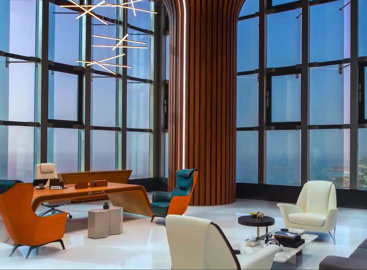 An office lounge with modern furniture and large windows offering a city view.