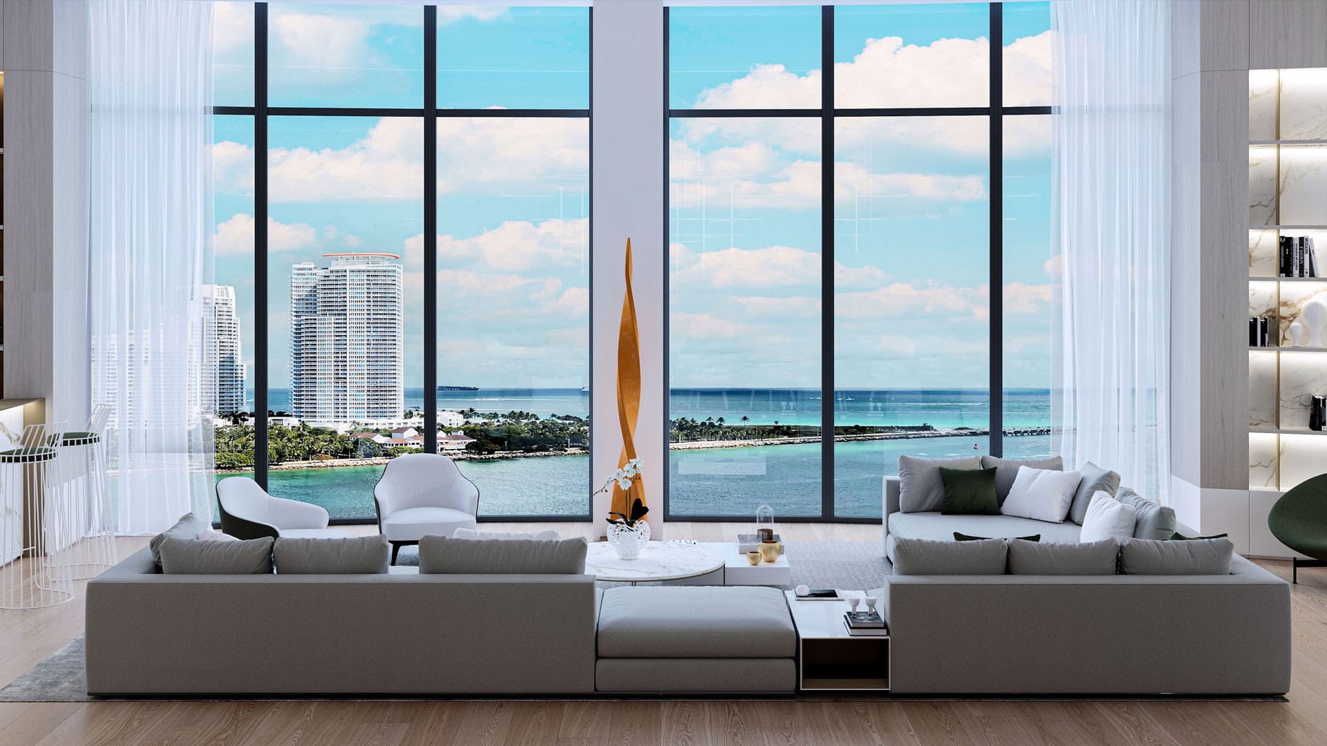 A chic living room with a large modular sofa facing a breathtaking floor-to-ceiling window view of the ocean and skyline, accented by sheer curtains and modern decor, creating a luxurious and serene space.