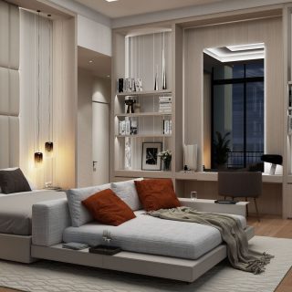 A contemporary bedroom with a large bed, white and orange pillows, elegant wall-mounted lighting, and a reading nook by the window, complemented by built-in bookshelves and a cozy chair, all in a palette of neutral tones.